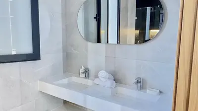 a white bathroom with a sink and a mirror at Villa de Rêve sans vis-à-vis à Marrakech in Marrakech