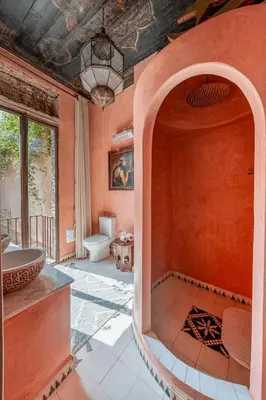 a bathroom with a tub and a toilet in a room at Riad Royal Koubba in Marrakech