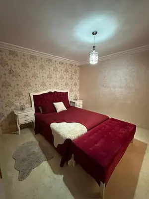 a bedroom with a large red bed in a room at Riad Arfoud Duplex Fully Equiped in Marrakech