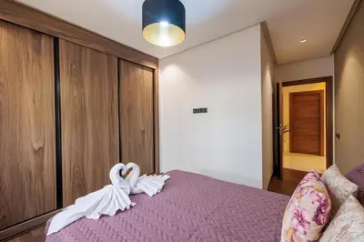 a bedroom with a purple bed with swans on it at Moderne appart Gueliz 3 ch parking Carrefour in Marrakech