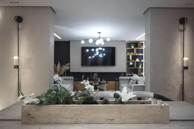 a living room with a tv and a table with flowers at Majorelle Garden Gem in Marrakech