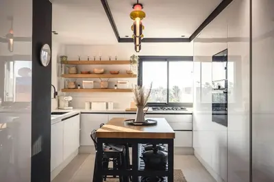 a kitchen with a small table and a window at Majorelle Garden Gem in Marrakech