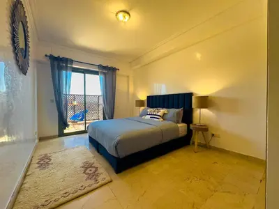 a bedroom with a large bed and a window at Gueliz 2-BR Apt Pool, Close to Majorelle Garden in Marrakech