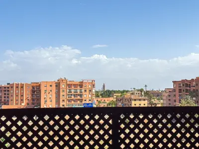 a view of a city from a balcony with buildings at Gueliz 2-BR Apt Pool, Close to Majorelle Garden in Marrakech