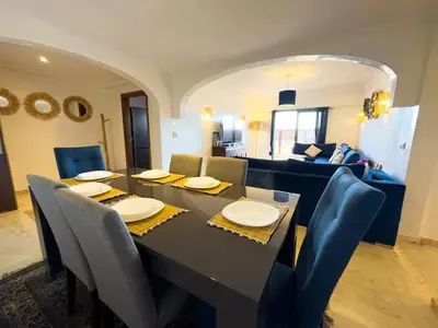 a dining table and chairs in a living room at Gueliz 2-BR Apt Pool, Close to Majorelle Garden in Marrakech