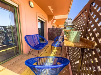 a balcony with blue chairs and a table and a window at Gueliz 2-BR Apt Pool, Close to Majorelle Garden in Marrakech