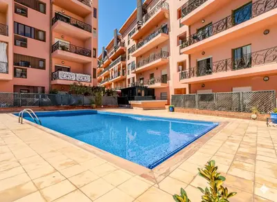 a swimming pool in front of a building at Gueliz 2-BR Apt Pool, Close to Majorelle Garden in Marrakech