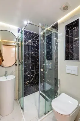 a bathroom with a glass shower and a toilet at comfortable equipped apartment in Marrakech