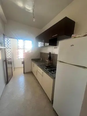 a kitchen with a white refrigerator and a stove at Appartement Marrakech in Marrakech