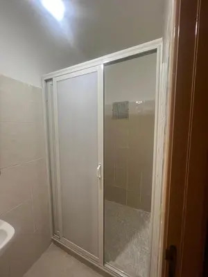 a shower with a glass door in a bathroom at Appartement Marrakech in Marrakech