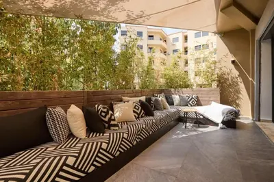 a couch on a patio with pillows on it at luxueux duplex avec piscine privée in Marrakech