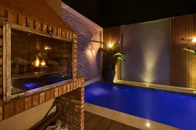 a swimming pool in a house with a fireplace at Luxurious duplex with a private pool in Marrakech