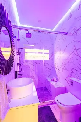 a bathroom with a sink toilet and a mirror at Cosy appartement bed 1 in Marrakech