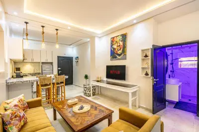 a living room with a purple door and a table at Cosy appartement bed 1 in Marrakech