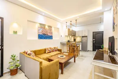 a living room with a couch and a table at Cosy appartement bed 1 in Marrakech