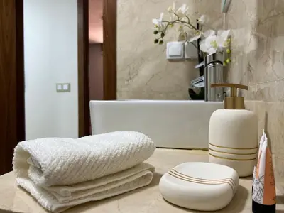 a bathroom with a sink and towels on a counter at Beautiful Duplex Fast Wi-Fi Terrace Pool in Marrakech