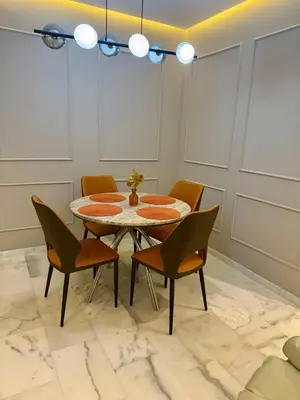 a dining room with a table and chairs at Le Nid Hermès in Marrakech