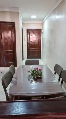 a meeting room with a table with flowers on it at Happy Relaxing home in Marrakech