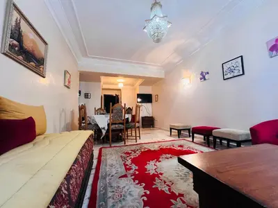 a living room with a couch and a table at Résidence belle vie 6 avec piscine in Marrakech