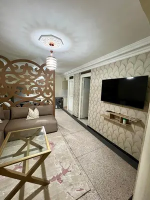 a living room with a couch and a television on a wall at Apartment in the center of Marrakesh in Marrakech