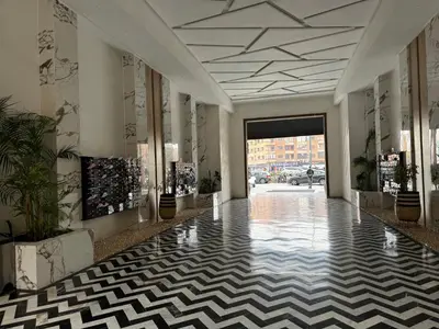 a lobby with ailed floor and a hallway at Super duplexe en plein Marrakech in Marrakech