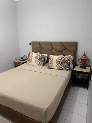 a bedroom with a large bed with two end tables at Apartment in the heart of Gueliz in Marrakech