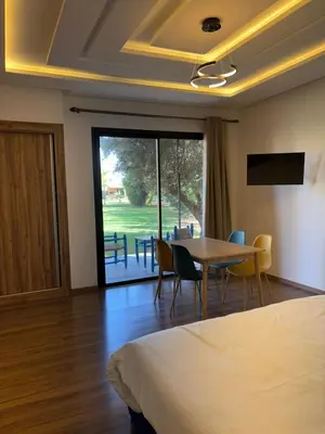 a hotel room with a bed and a table and chairs at Villa Sofia And Spa in Marrakech