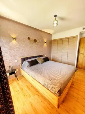 a bedroom with a large bed in a room at Marrakech apartment with pool - Pearl Garden in Marrakech