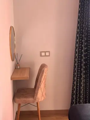 a chair in a room with a mirror and a desk at Marrakech apartment with pool - Pearl Garden in Marrakech