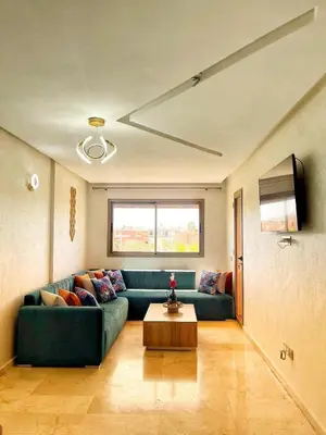 a living room with a green couch and a table at Marrakech apartment with pool - Pearl Garden in Marrakech