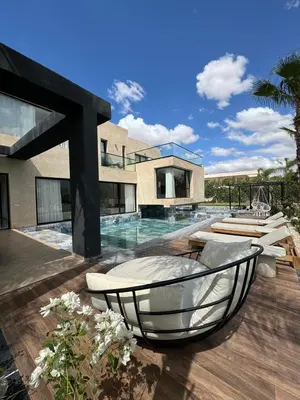 a villa with a swimming pool and a house at Villa Bora in Marrakech