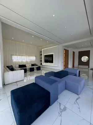 a large living room with blue couches and a couch at Villa Bora in Marrakech