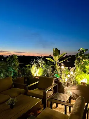 a patio with couches and tables and a view at Charmant appartement lumineux au cœur de la ville in Marrakech