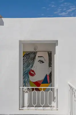 a painting of a woman on the side of a building at Riad Byerd in Marrakech