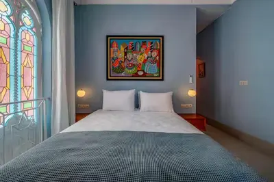 a bedroom with a large bed with a stained glass window at Riad Byerd in Marrakech