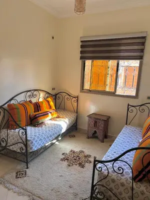 a bedroom with two beds and a window at Modern apartment, 10 minutes from the airport in Marrakech