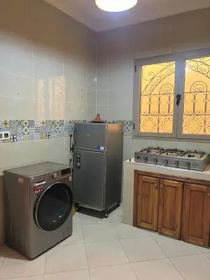 a kitchen with a washing machine and a stove at Modern apartment, 10 minutes from the airport in Marrakech