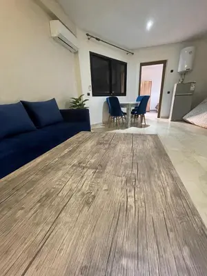 a living room with a blue couch and a table at 3wina immobilier in Marrakech