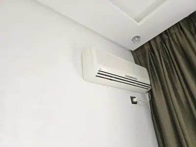 a air conditioner in a room with a curtain at Appartement ECHRIFIA GARDENS in Marrakech