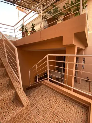 a house with a staircase and a balcony at Peaceful Retreat with pool in Marrakech