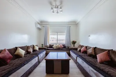 a living room with a large couch with pillows at Chic et climatisé au centre de gueliz in Marrakech
