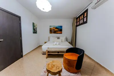 a bedroom with a bed and a chair at MVIEW Villas in Marrakech