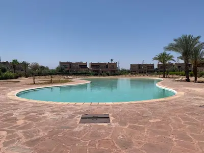 a small pool in the middle of a desert at Amour de Nuits in Douar Caïd Layadi