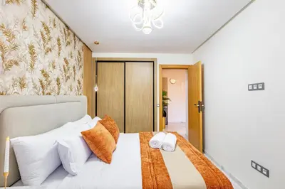 a bedroom with a bed with white pillows at Guéliz Centre-Appartement Chic près Carré Eden in Marrakech
