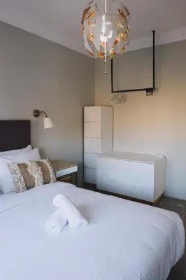 a bedroom with a large white bed and a chandelier at Beldi-Chic & Moroccan Sweetness in Marrakech