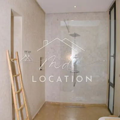a bathroom with a shower with the words mad location on the wall at Villa Dar M in Marrakech