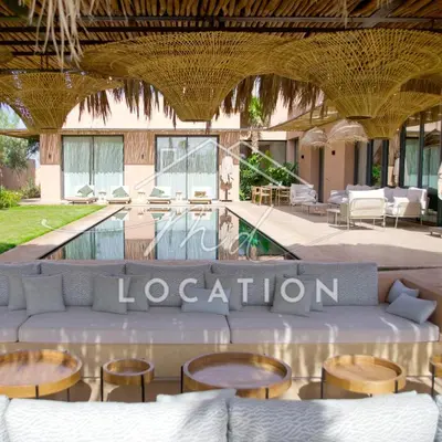 a room with a couch and tables and a pool at Villa Dar M in Marrakech