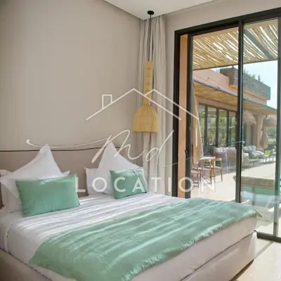 a bedroom with a bed and a view of a patio at Villa Dar M in Marrakech