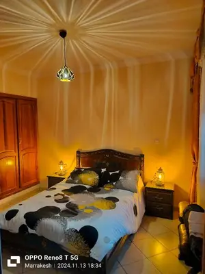 a bedroom with a bed and two night stands at le Marrakchi in Marrakech
