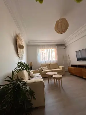 a living room with a couch and a tv at The Pearl of Guelliz in Marrakech
